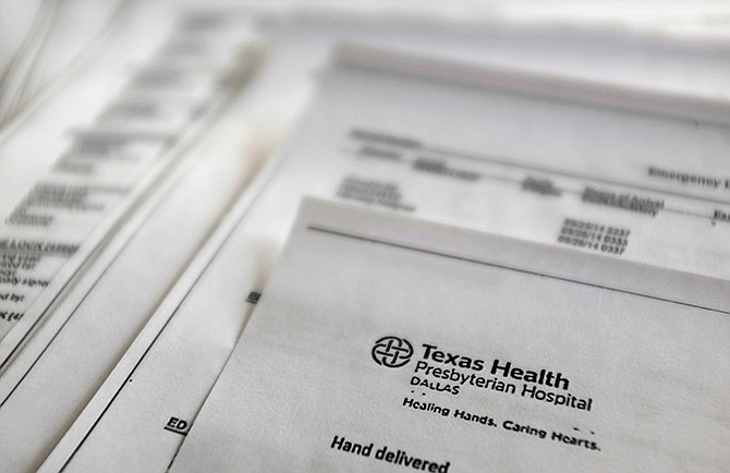 This Friday, Oct. 10, 2014 photo shows a copy of Thomas Eric Duncan's medical records from Texas Health Presbyterian Hospital, provided by Duncan's family to The Associated Press. The records encompass his time in the emergency room, his urgent return to the hospital two days later and a chronicle of his steep decline as his organs began to fail. Duncan carried the deadly Ebola virus with him from his home in Liberia, though he showed no symptoms when he left for the United States. He arrived in Dallas on Sept. 20 and fell ill several days later. 