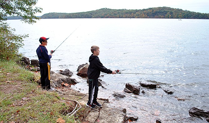 Riley Carpenter, left, and Tyler Miller, both of Camdenton, enjoyed fishing on the banks of Lake of the Ozarks State Park for the first time during the Take a Kid Fishing Derby Saturday.