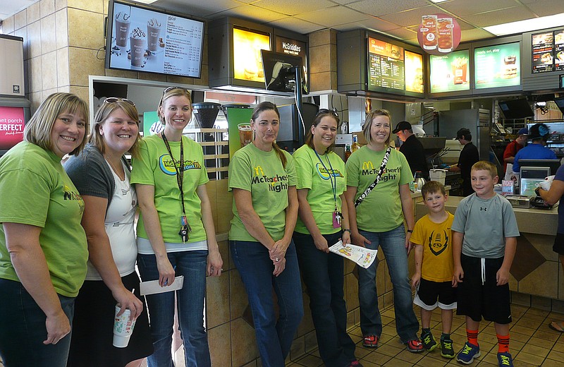 Teachers anxiously accepted students coloring sheets for participating in McTeacher Night, Tuesday, Oct. 7. From left to right, Susan Ferrell, Stacy Edwards, Courtney Stratton, Amy Mouse, Sarah Hays and Kendra Hall with students Colin Altoff and Evan Turner.