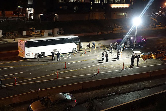 Law enforcement investigate the scene of a stabbing aboard a tour bus late Tuesday, in Norwalk, Connecticut. A man who stabbed passengers on the casino-bound tour bus on Interstate 95 was fatally shot by state police, officials said Wednesday. 