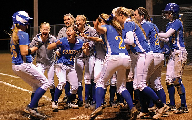 The Fatima Lady Comets rush the field to celebrate following a dramatic come-from-behind victory in the bottom of the seventh inning over the Blair Oaks Lady Falcons in Wednesday's Class 2 Sectional match-up in Westphalia, Mo.