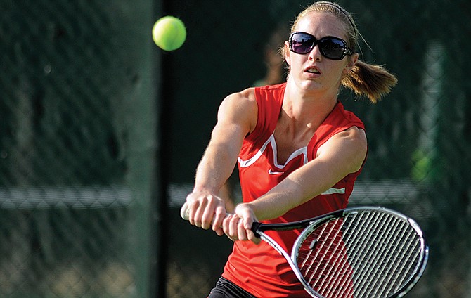 Jefferson City's Paige Smith follows through on a backhand return during a doubles match last month at Washington Park.