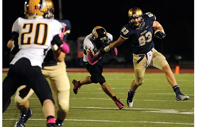 Helias tight end Hale Hentges looks for open running room behind his blockers as he breaks through a tackle attempt by Sullivan linebacker Brent Davis.