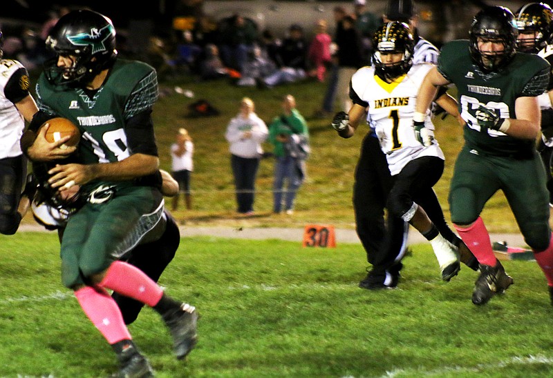 North Callaway senior quarterback Cole Branson tries to break away from a Van-Far defender during the Thunderbirds' 40-30 EMO victory over the Indians on Friday night in Kingdom City.