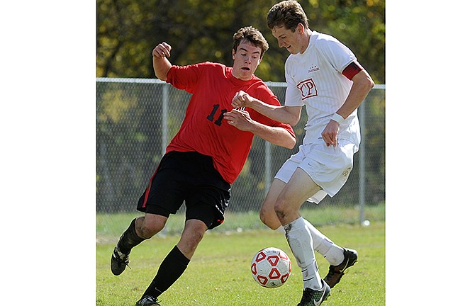 Spencer Bone of Jefferson City tries to dribble around Chaminade midfielder Steve Nikodem as the Jays try to mount an attack in the first half of Saturday's game in the Art Firley Soccer Shootout at 179 Soccer Park.