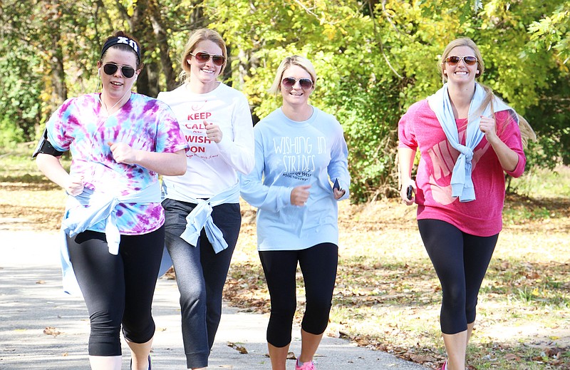 A group of runners close in on the finish line at the William Woods University Chi Omega sorority's Wish Walk on Saturday. Participants ran and walked five miles of the Stinson Creek Trail at Memorial Park. The event raised more than $1,500 that will be donated to the Make a Wish Foundation.