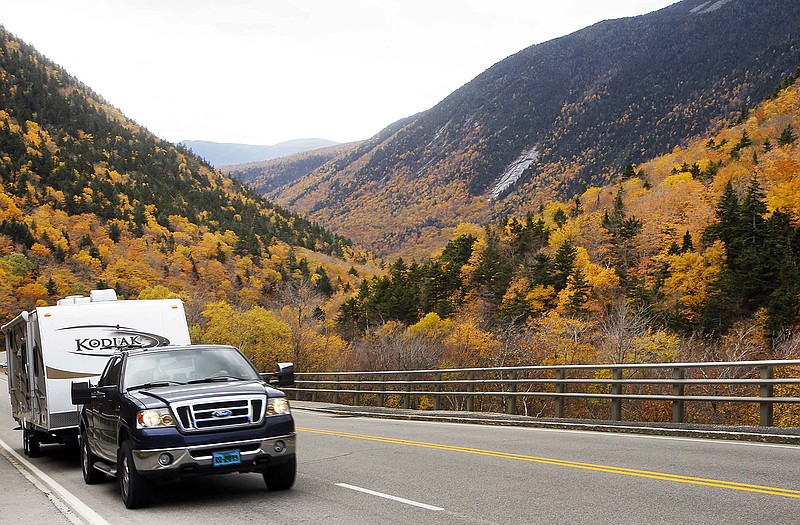A camper drives through Crawford Notch in Carroll, N.H., as foliage reaches peak in New Hampshire's White Mountains. Officials say tourists will spend upwards of $1 billion to catch a glimpse of the red, yellow and orange hues on the trees, and the windfall is steadily rising as the economy regains strength.
