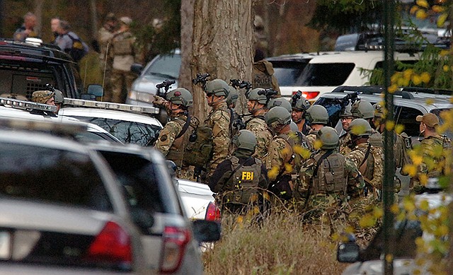 FBI agents prepare to patrol the woods on Lower Swiftwater Road on Saturday, during a massive manhunt for killer Eric Frein in Swiftwater, Pennsylvania.