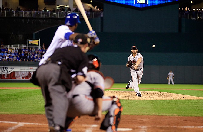 San Francisco Giants pitcher Madison Bumgarner throws during the first inning of Game 1 of baseball's World Series against the Kansas City Royals Tuesday, Oct. 21, 2014, in Kansas City, Mo. 