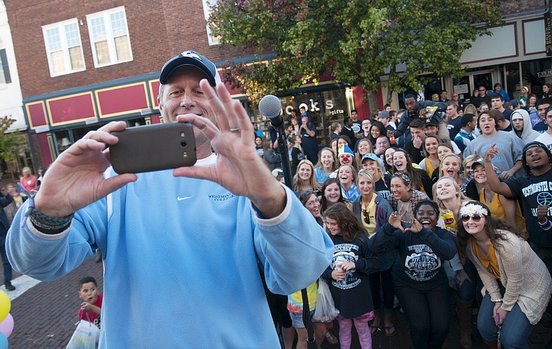 Westminster College Athletic Director Matt Mitchell takes a selfie with Westminster College students Wednesday on Court Street during the school's homecoming pep rally. 