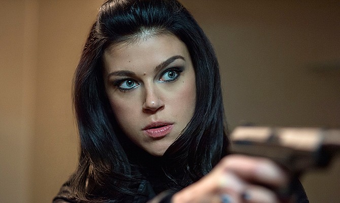 This photo released by Lionsgate shows Adrianne Palicki stars as Ms. Perkins in a scene from the film, "John Wick."