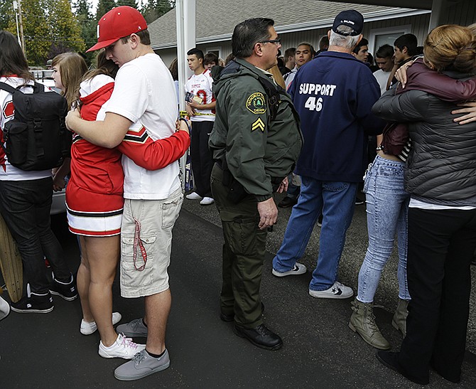 Students comfort each other at a church Friday, where students were taken to reunite with parents following a shooting at Marysville Pilchuck High School in Marysville, Washington. 