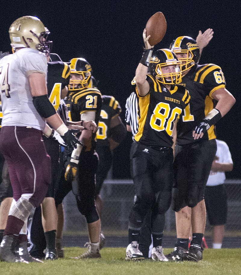 Fulton junior free safety Andy Baysinger shows off the ball to the crowd at Robert E. Fisher Stadium after recovering a fumble in the Hornets' 65-28 romp over Eldon in the Class 3, District 6 quarterfinals on Friday night.