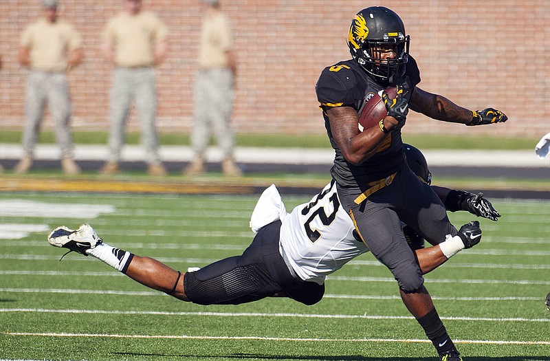 Missouri running back Marcus Murphy is tackled by Vanderbilt's Andrew Williamson as he runs upfield during Saturday's game at Faurot Field. 