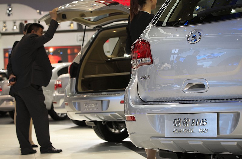 Visitors look at a Great Wall Motors Haval H6 SUV during the Beijing International Automotive Exhibition in Beijing. Analysts expect China to be the biggest market for SUVs in the world by 2018.
