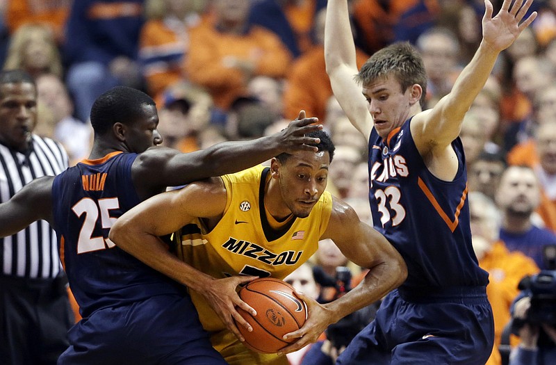 Missouri's Johnathan Williams III tries to squeeze past a pair of Illinois defenders during a game last season in St. Louis. Williams will miss tonight's opening exhibition game with an injury.