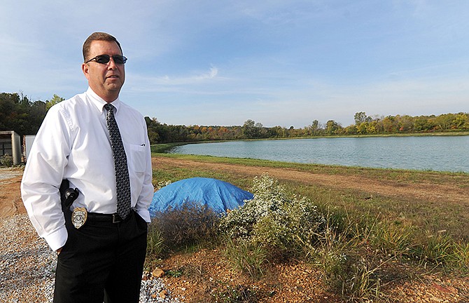 Webb City interim city administrator Carl Francis stands near a reservoir in the city's wastewater treatment plant on Friday. Under a city plan, that area will be expanded into a wetlands area named the Center Creek Valley Wetlands, where zinc deposits will be dumped and encapsulated. (AP Photo/The Joplin Globe, Laurie Sisk)