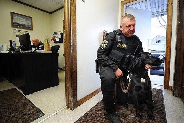 Fort Edward police officer Scott Stark holds  "Nass", a police dog that tracked down fleeing fugitive Gregory Lewis Wednesday, in Fort Edward, New York.