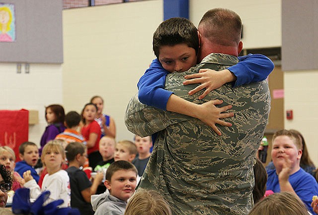 South Callaway fourth-grader Carson Russell tightly embraces his father - a sergeant in the Air Force Reserves who had been in Afghanistan for almost seven months. His father surprised him at school Thursday after coming home from Afghanistan.