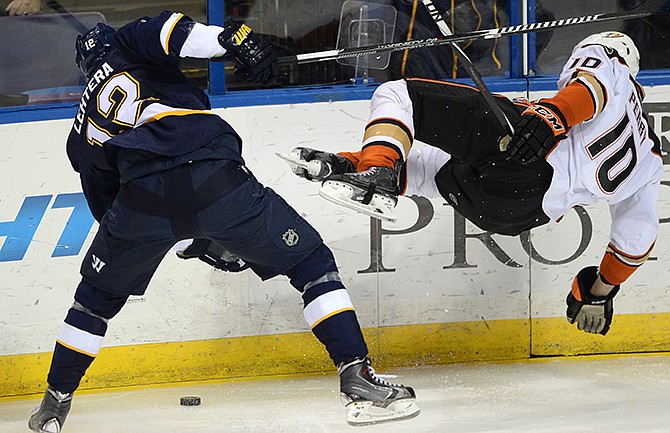 St. Louis Blues' Jori Lehtera (12), of Finland, is called for tripping Anaheim Ducks' Corey Perry (10) during the second period of an NHL hockey game, Thursday, Oct. 30, 2014, in St. Louis.