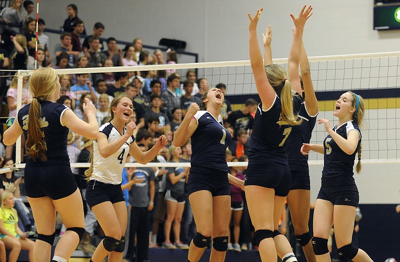 The Helias Lady Crusaders celebrate winning a point during the district tournament earlier this month at Rackers Fieldhouse.