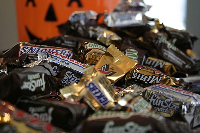 This 2007 photo shows "Fun Size" and "Mini" candies in New York. The cost of the ingredients in chocolate is rising, and the nation's biggest candy makers have already warned that shoppers are going to see price hikes in 2015. 