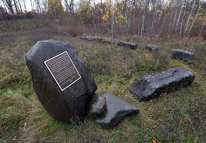 A plaque remembers those buried in a Colonial-era cemetery on Rogers Island on Wednesday in Fort Edward, New York. The cemetery could hold the remains of hundreds of people, including some of the famous frontier fighters known as Rogers' Rangers. 