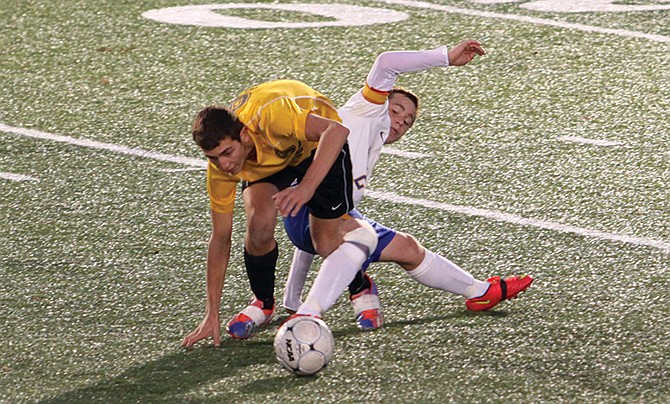 Caleb Bauer of Fatima battles a Sullivan player for control of the ball during Wednesday night's Class 2 District
10 championship game in St. James.