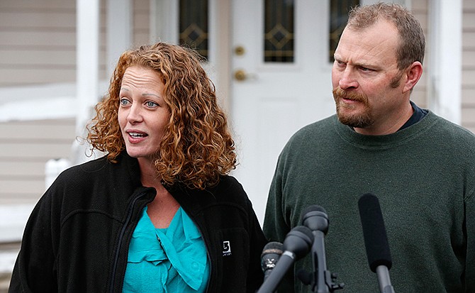 Nurse Kaci Hickox is accompanied by her boyfriend Ted Wilbur as she speaks to reporters outside their home, Friday, Oct. 31, 2014, in Fort Kent, Maine. A Maine judge gave Hickox the OK to go wherever she pleases, handing state officials a defeat Friday in their bid to restrict her movements as a precaution against Ebola.