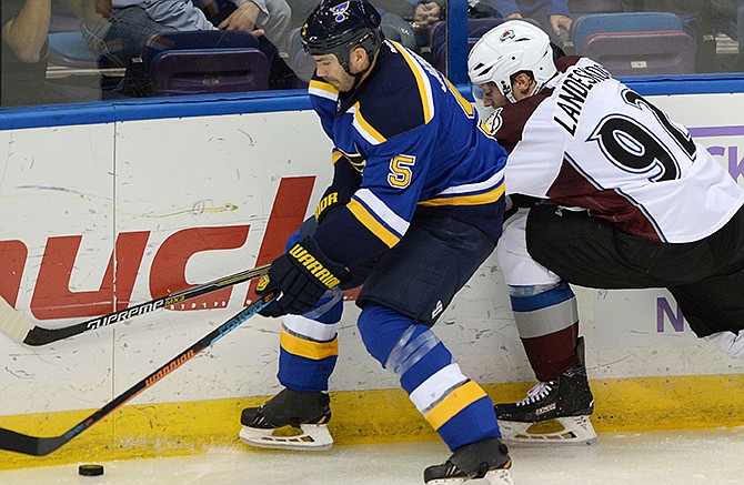 St. Louis Blues' Barret Jackman (5) and Colorado Avalanche's Gabriel Landeskog (92), of Sweden, vie for the puck during the second period of an NHL hockey game, Saturday, Nov. 1, 2014, in St. Louis. 