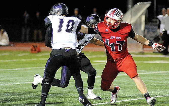 Jefferson City Jay Travis Burris forces Fort Zumwalt West quarterback Chase Brown to fumble Friday at Adkins Stadium.