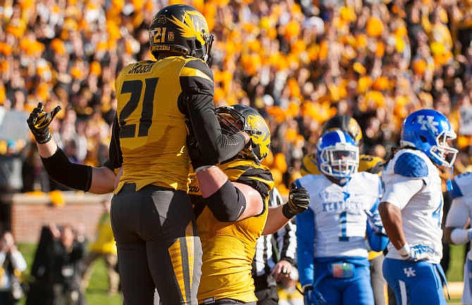 Missouri wide receiver Bud Sasser, left, is hoisted in the air by teammate Evan Boehm after he scored a touchdown during the second quarter of an NCAA college football game against Kentucky, Saturday, Nov. 1, 2014, in Columbia, Mo. 
