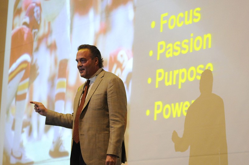 Kansas City Chiefs Hall of Famer Nick Lowery talks to William Woods University students Wednesday night inside Cutlip Auditorium. During his inspirational lecture, Lowery discussed four major points - focus, passion, purpose and power - and how those factors influence life.