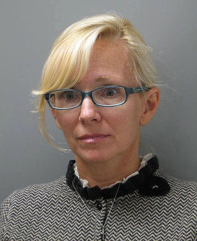 In this photo provided Wednesday by the Delaware State Police, Molly Shattuck, of Baltimore, poses for a police mug shot. Shattuck, 47, a former Baltimore Ravens cheerleader and the estranged wife of a prominent Maryland energy executive has been arrested and charged in connection with a sexual relationship involving a 15-year-old boy. Shattuck was indicted Monday on two counts of third-degree rape, four counts of unlawful sexual contact and three counts of providing alcohol to minors.