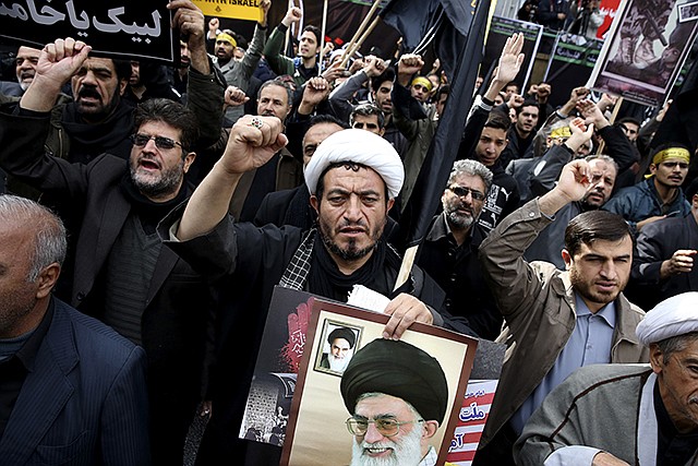 Iranians chant slogans in an anti-U.S. demonstration in front of the former U.S. Embassy, during the holy day of Ashoura, in Tehran, Iran, on Tuesday. Thousands of Iranians chanted "Down with America" at a major anti-U.S. rally marking the anniversary of the 1979 takeover of the U.S. Embassy in Tehran, just days ahead of a key meeting between the two nations' top diplomats over Iran's controversial nuclear program.