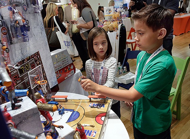 Evan and Jillian, no last name given, of EvanTubeHD, try NBA Heros, by Jazwares, at the TTPM Holiday Showcase, in New York. Evan has over 800 million views on EvanTubeHD, where he reviews toys.