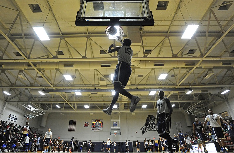 Lincoln forward Malcolm McDonald throws down a reverse dunk as the Blue Tiger men's and women's basketball teams warm-up at the start of Wednesday night's Blue Madness at Jason Gym.