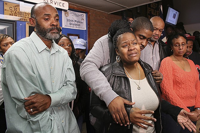 Family members surround Keisha Gaither, center, mother of kidnapping victim Carlesha Freeland-Gaither, during a news conference in Philadelphia on Tuesday. Carlesha, a woman abducted Sunday night from a Philadelphia street, was found safe outside Baltimore on Wednesday. The man who kidnapped her was arrested, according to police. She suffered minor injuries but was generally doing OK.