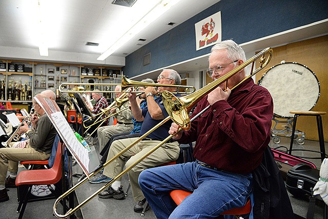 Hugh Waggoner plays the trombone during Jefferson City Symphonic Band's Tuesday evening rehearsal. The band will perform at 2 p.m. Sunday at the Capitol Rotunda.