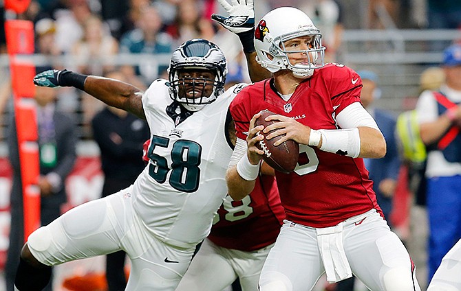 Arizona Cardinals quarterback Carson Palmer (3) looks to throw as Philadelphia Eagles outside linebacker Trent Cole (58) pursues during the first half of an NFL football game, Sunday, Oct. 26, 2014, in Glendale, Ariz. 