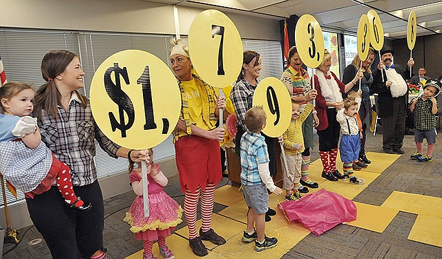 Helping to illustrate the generosity of the local community, volunteers representing United Way agencies held up placards revealing the total amount pledged to this year's campaign. The stated goal was $1.75 million, and the projected total shows they will have surpassed that amount by $40,000.