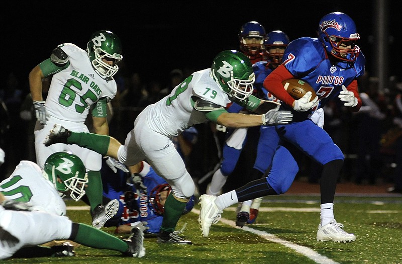 California free safety Landon Mouse tries to break free from Blair Oaks lineman Chance Cumpton after picking off a pass in the second quarter of the team's game Oct. 3 in California. The teams will meet again tonight with a berth in the Class 3 quarterfinals on the line.