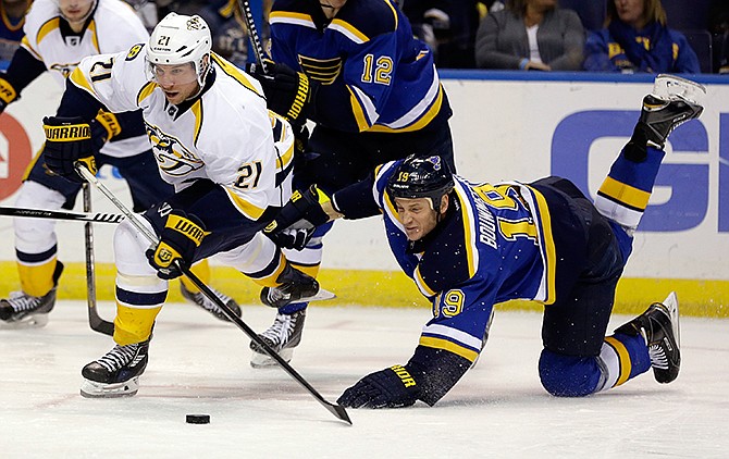 Nashville Predators' Derek Roy, left, shoots as St. Louis Blues' Jay Bouwmeester watches during the third period of an NHL hockey game Saturday, Nov. 8, 2014, in St. Louis. The Predators won 2-1. 