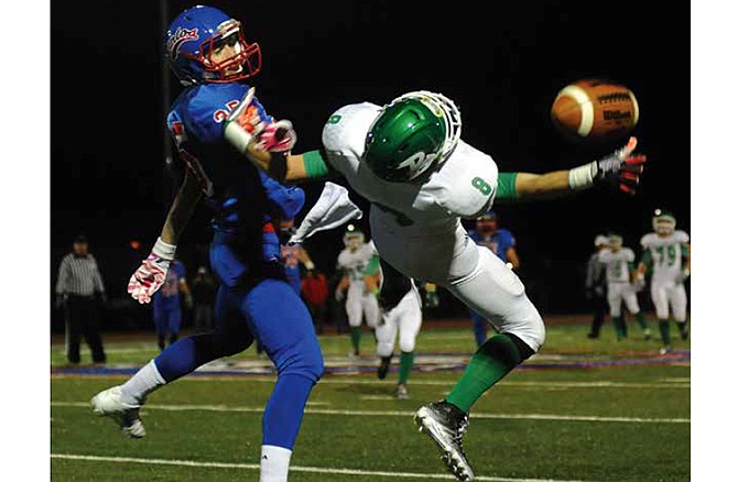 
Blair Oaks wide receiver Adam Schell lays out backward while being guarded by California defensive back Drew Norton but can't come up with the deep pass during Friday night's Class 3 District 6 championship at Riley Field in California, Mo.