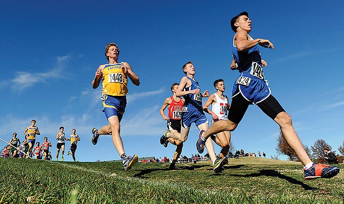 Fatima's Hunter Hennier (1448) and Russellville's Alex M. Thompson (1535) run with the race leaders after breaking away from the pack in the early stages of the Class 2 boys race in Saturday's MSHSAA Championships at the Oak Hills Golf Center in Jefferson City.