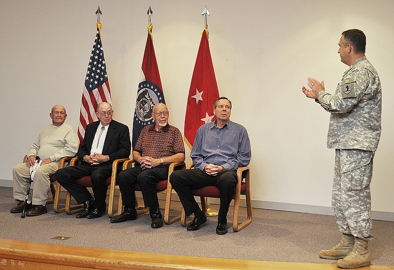 Maj. Gen. Stephen Danner applauds four Mid-Missouri veterans who received Silver Star Banners during a ceremony Monday at the Missouri National Guard headquarters. The honored veterans are, from left, Bruce "Duane" Sublett, Carl Houston,  David Rackers and Dick Woods.