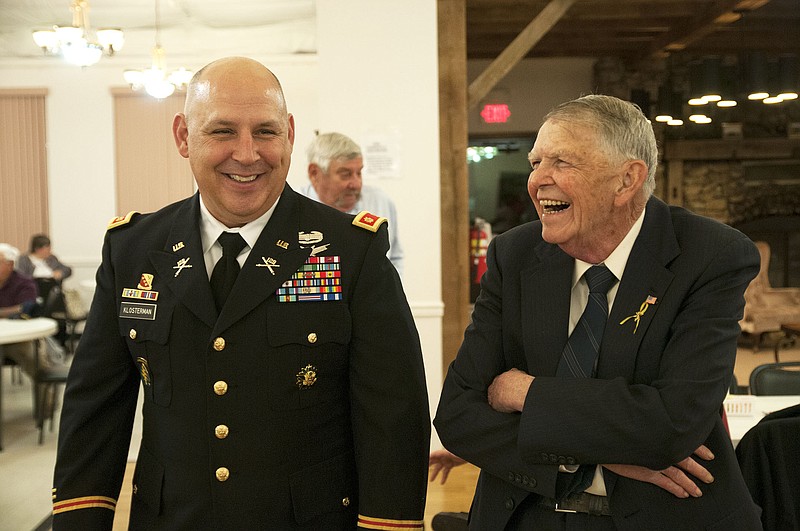 Major Jeff Klos shares a laugh with a veteran Tuesday night during the 95th annual Veteran's Day Banquet at the Callaway Senior Center. Klos was the guest speaker at the event and paid tribute to local veterans in his speech.