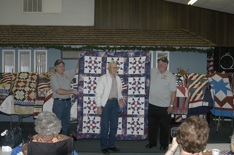 World War II Veteran Clyde Dummermuth is presented a Quilt of Honor. The quilt is held by members of California VFW Post 4345.