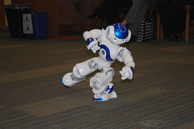 Buzz the robot demonstrates some of his abilities - including tai chi - during the Fulton School Board meeting Wednesday night. Buzz and his fellow robot Buddy will eventually be used in the classroom to help autistic students.