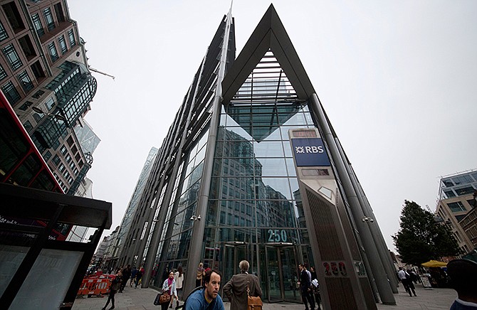 A Thursday, Sept. 11, 2014 photo from files showing an exterior view of the offices of Royal Bank of Scotland (RBS) in the City of London. Groups of traders with nicknames like the "Three Musketeers'' and the "A-Team" plotted over Internet chat rooms to manipulate currency markets for over five years, exchanging confidential information to boost profits at the expense of clients _ and then congratulating themselves for their own brilliance _ regulators said Wednesday, Nov. 12, 2014, in announcing $3.4 billion in fines against five banks, including RBS. 
